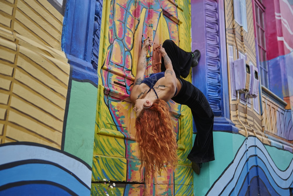 a woman climbing up the side of a building