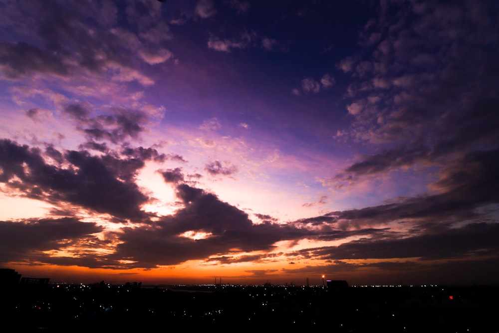 a purple and blue sky with some clouds