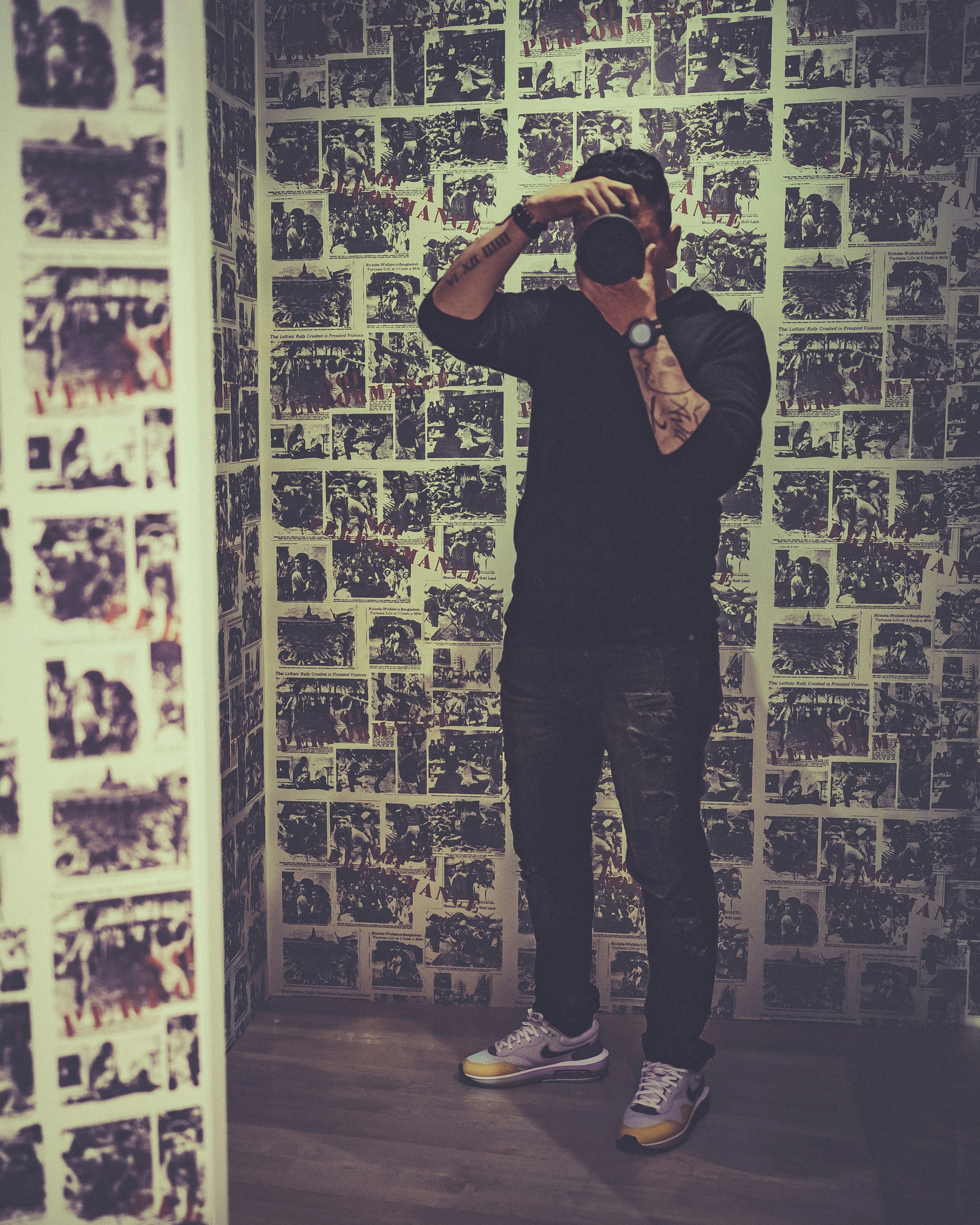 A man standing in front of a wall covered in pictures photo – Free Usa ...
