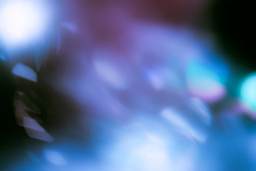 An abstract composition with soft focus and blurred light effects, featuring a blend of cool tones and subtle highlights. The image contains various shapes and gradients, giving it a dreamy and surreal atmosphere.