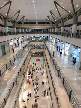 Wide shot of a busy shopping mall exterior with pigeon deterrent spikes installed.