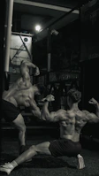 Close-up of a client’s back muscles before and after weight training at energofit, lit by bold yellow gym lights.
