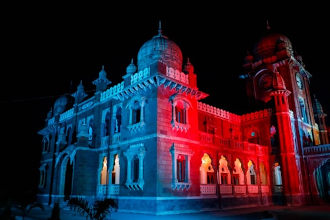 a large building lit up with red and blue lights