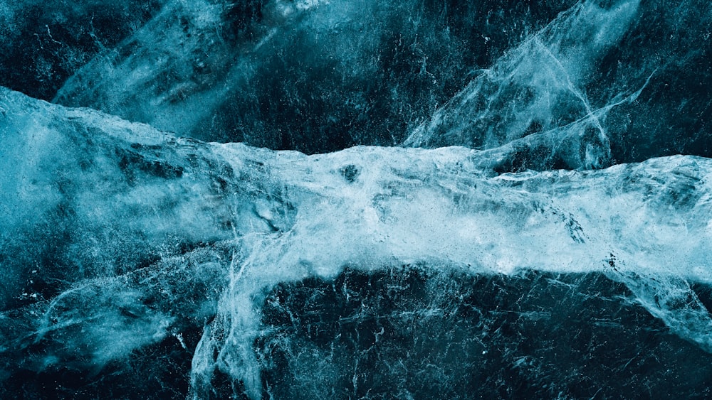 a blue and white photo of water and ice