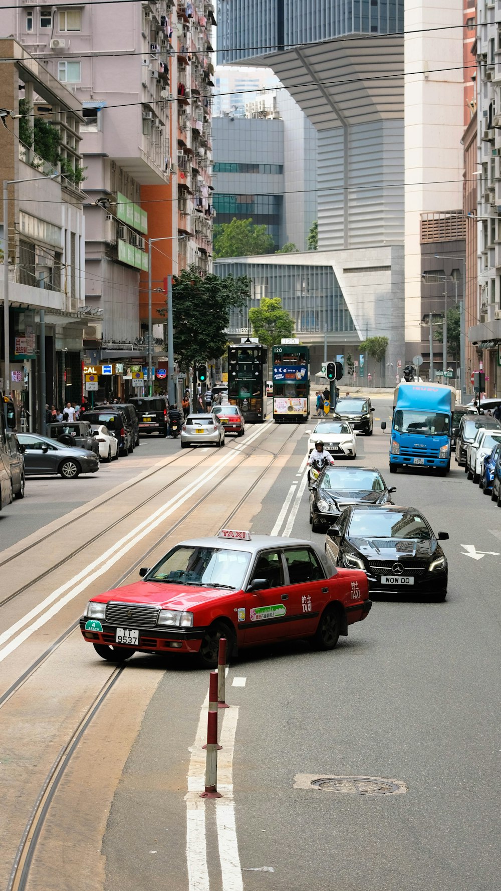 a street filled with lots of traffic next to tall buildings