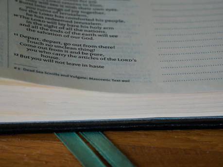 Open book showing annotated text with detailed footnotes and scholarly commentary.