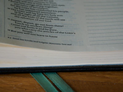 Close-up of an open book showing detailed annotations alongside the original text on cream-colored pages.