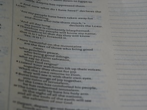 A close-up view of a page from a book, displaying text in a column format. The text appears to be religious in nature, mentioning salvation, Zion, and the Lord.
