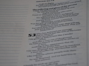 A close-up of a page from a document or book with printed text. The content appears to be structured in verses or lines, suggesting it might be from religious or poetic literature. The text is clear and formatted with both regular and bold fonts, with some numbers indicating sections.