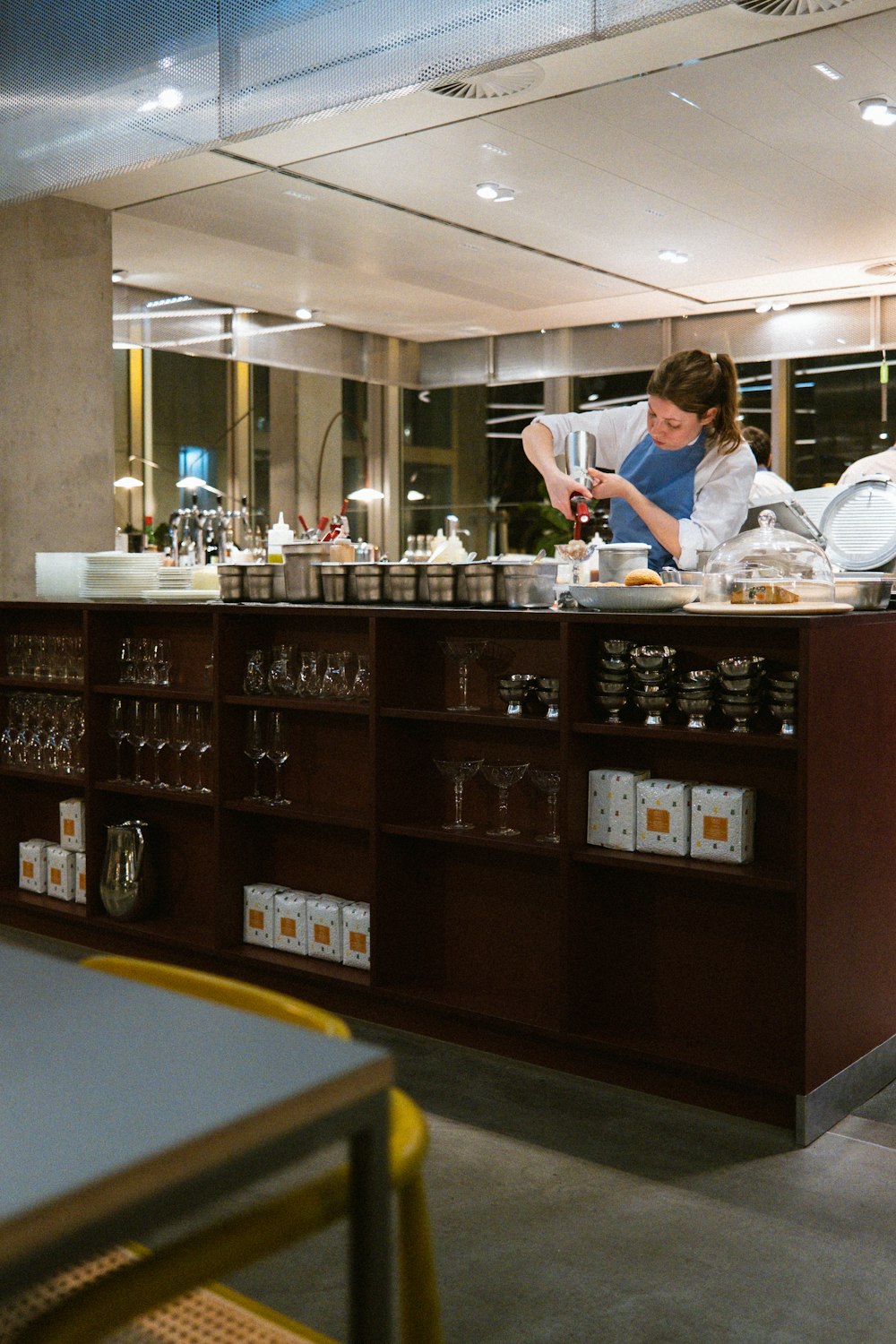 a woman in a kitchen preparing food on a counter