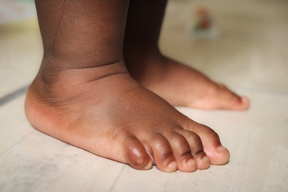 a close up of a child's bare foot on the floor