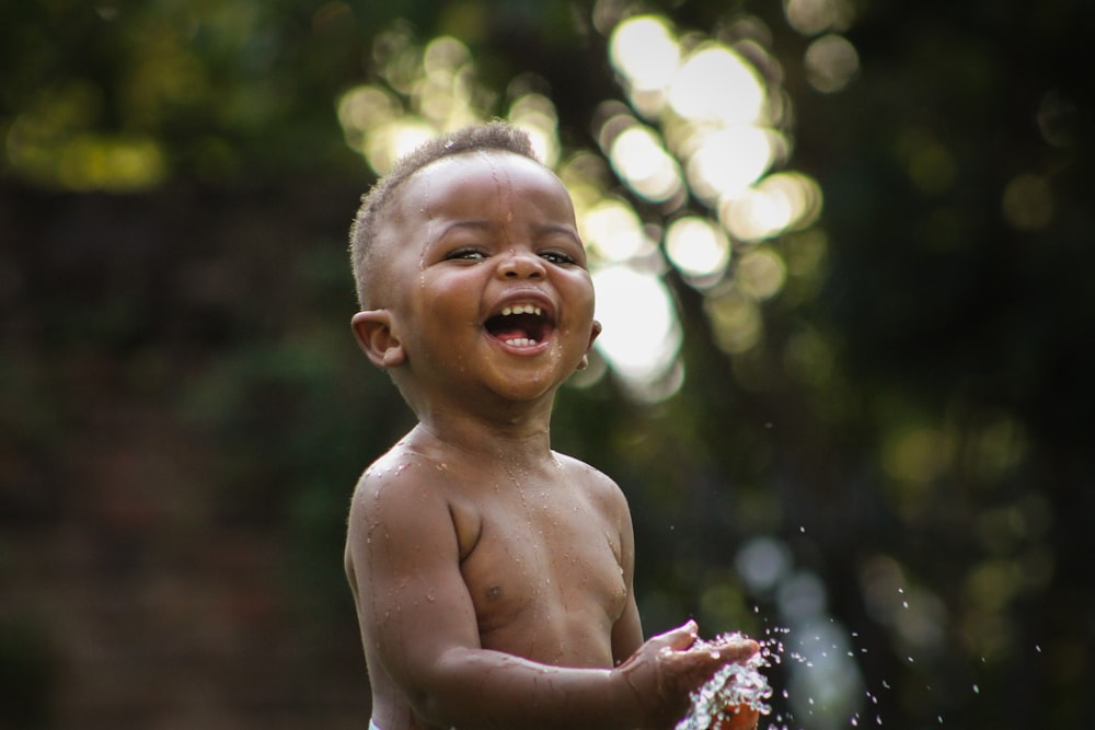 a little boy that is standing in the water