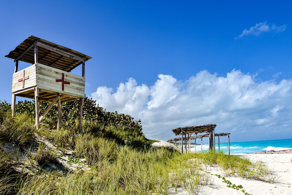 a lifeguard station on a beach with a cross on it