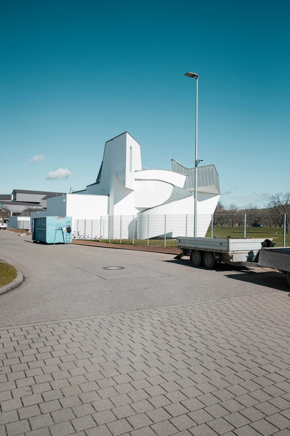 a large white building sitting on the side of a road