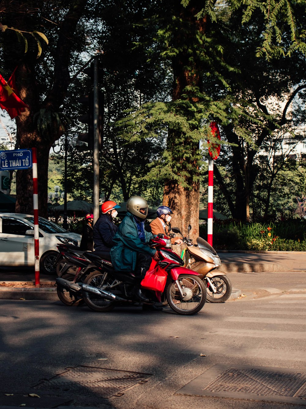 a group of people riding on the back of motorcycles