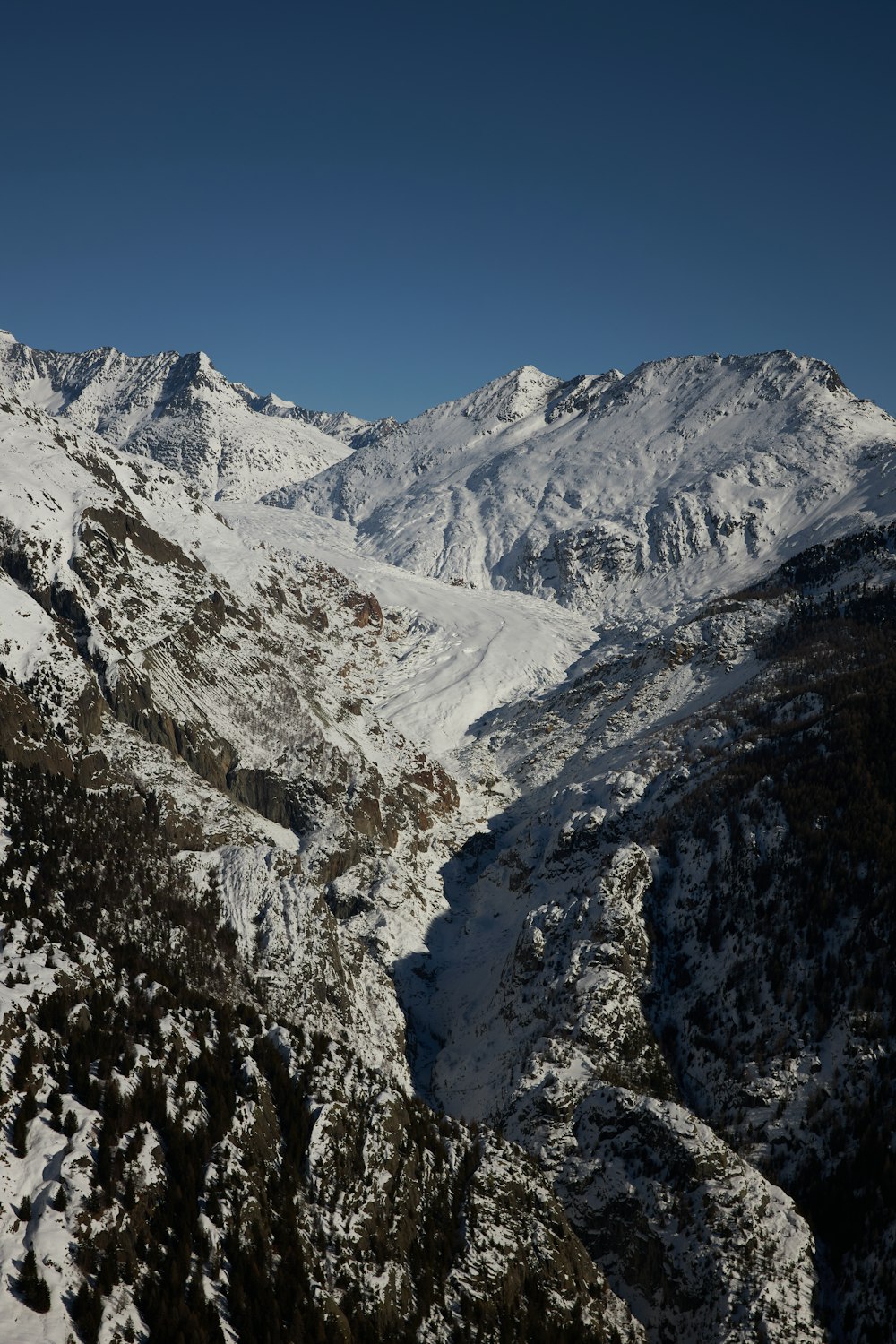 a view of a mountain range covered in snow