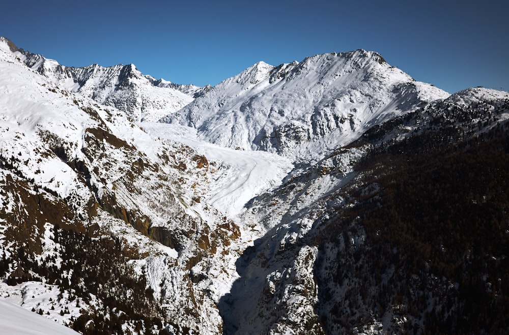 a view of a mountain range covered in snow