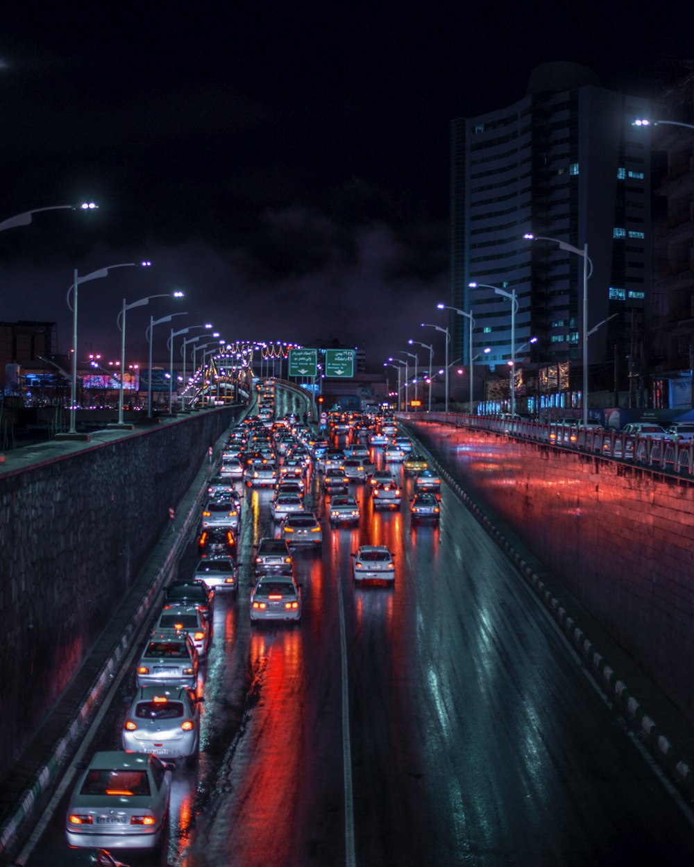 a city street filled with lots of traffic at night