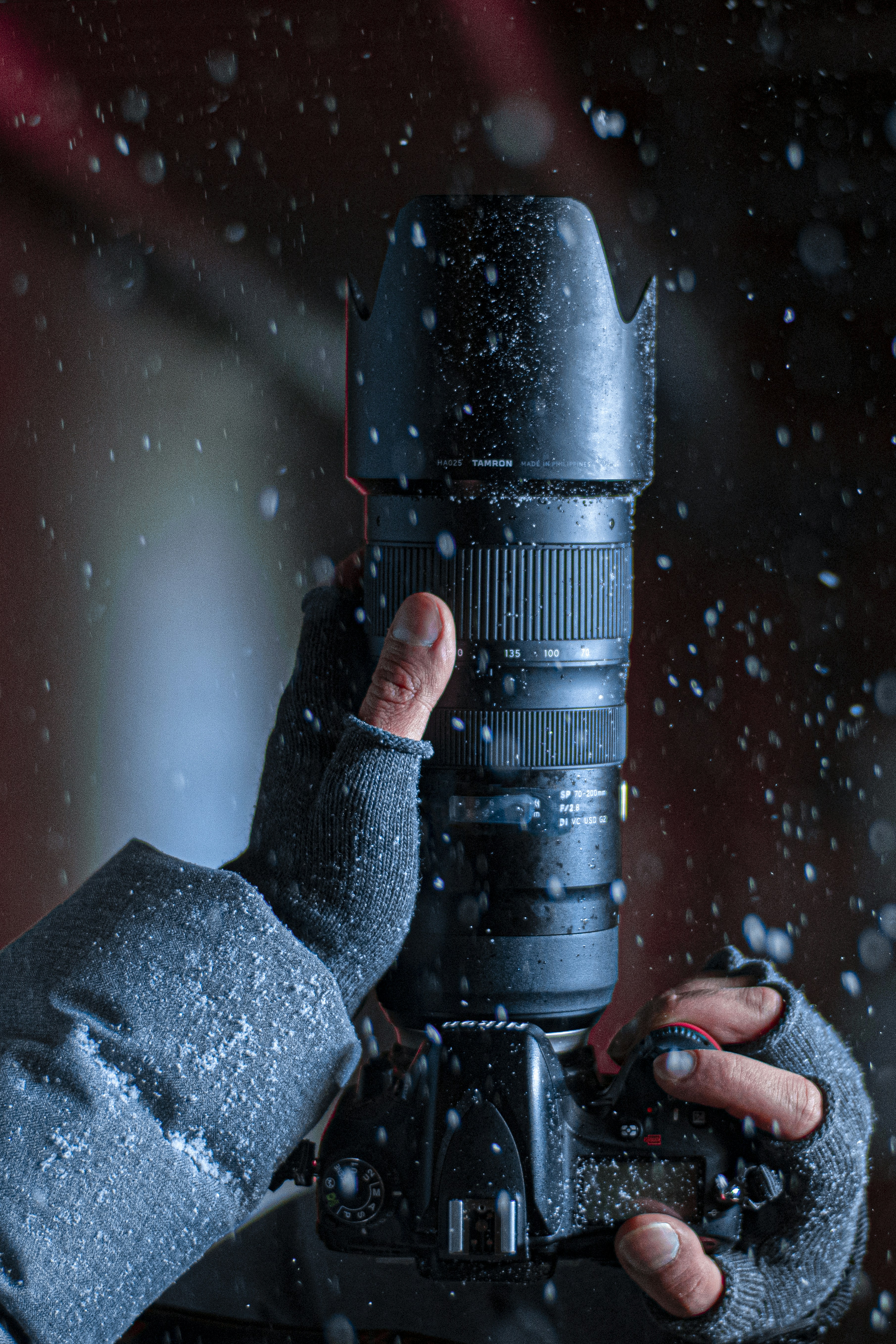 A person holding a camera in the snow photo – Free Man Image on Unsplash