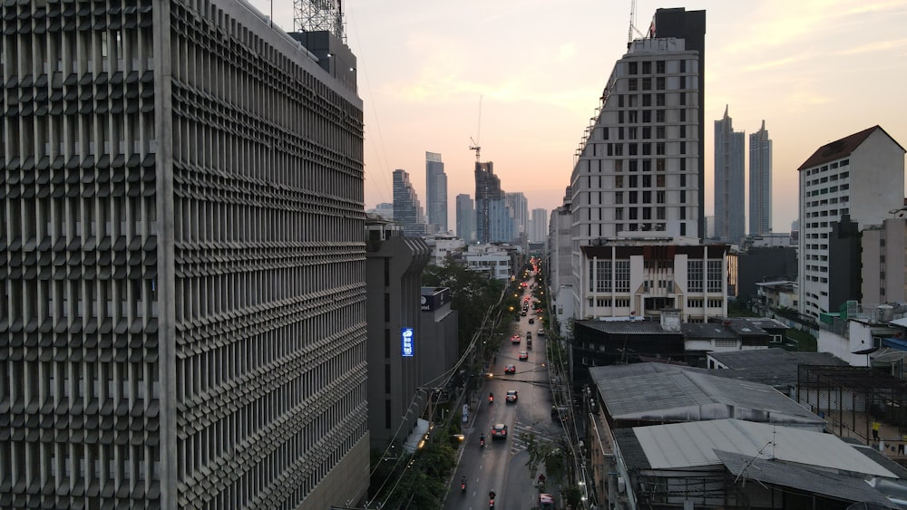 a city street with tall buildings in the background