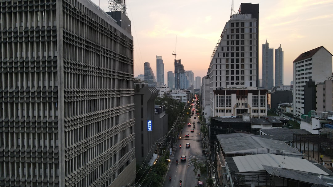 a city street with tall buildings in the background, Surawong Road #surawong