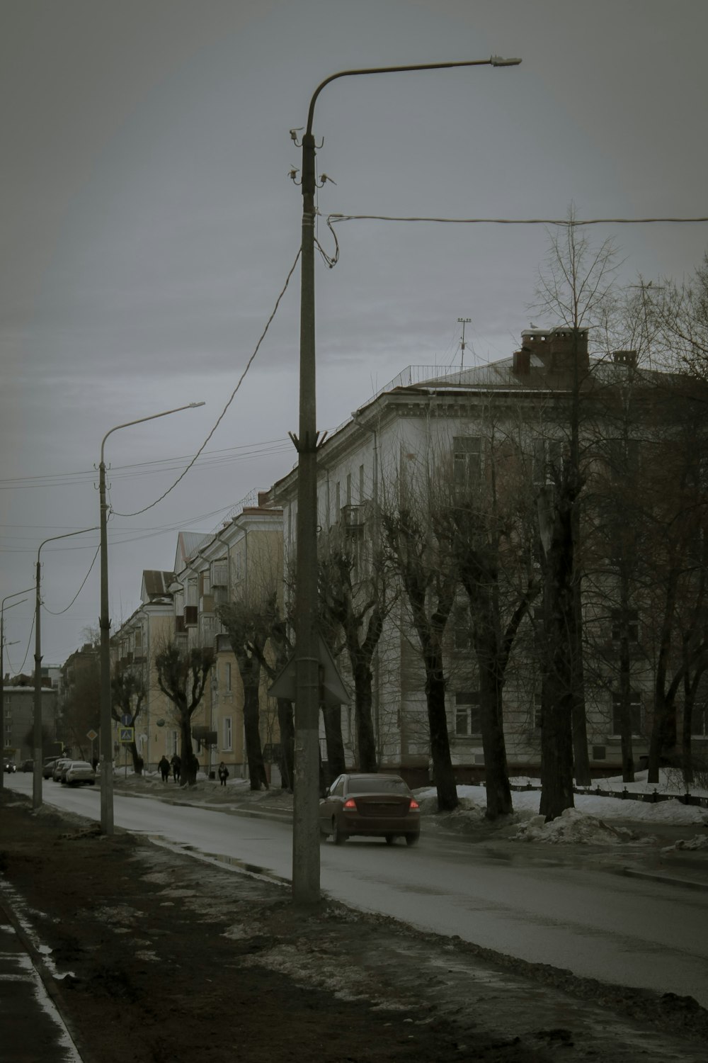 a city street with a few cars parked on the side of the road