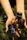 Close-up of hands unboxing a Madara Roots package with natural supplement bottles inside.