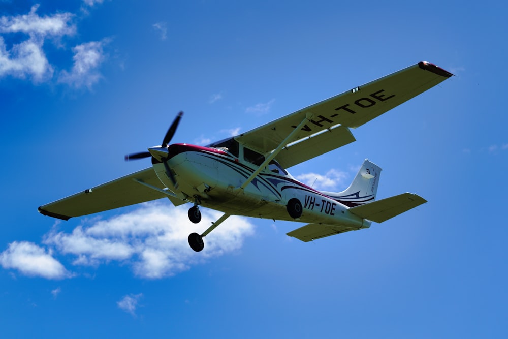 a small plane flying through a blue sky