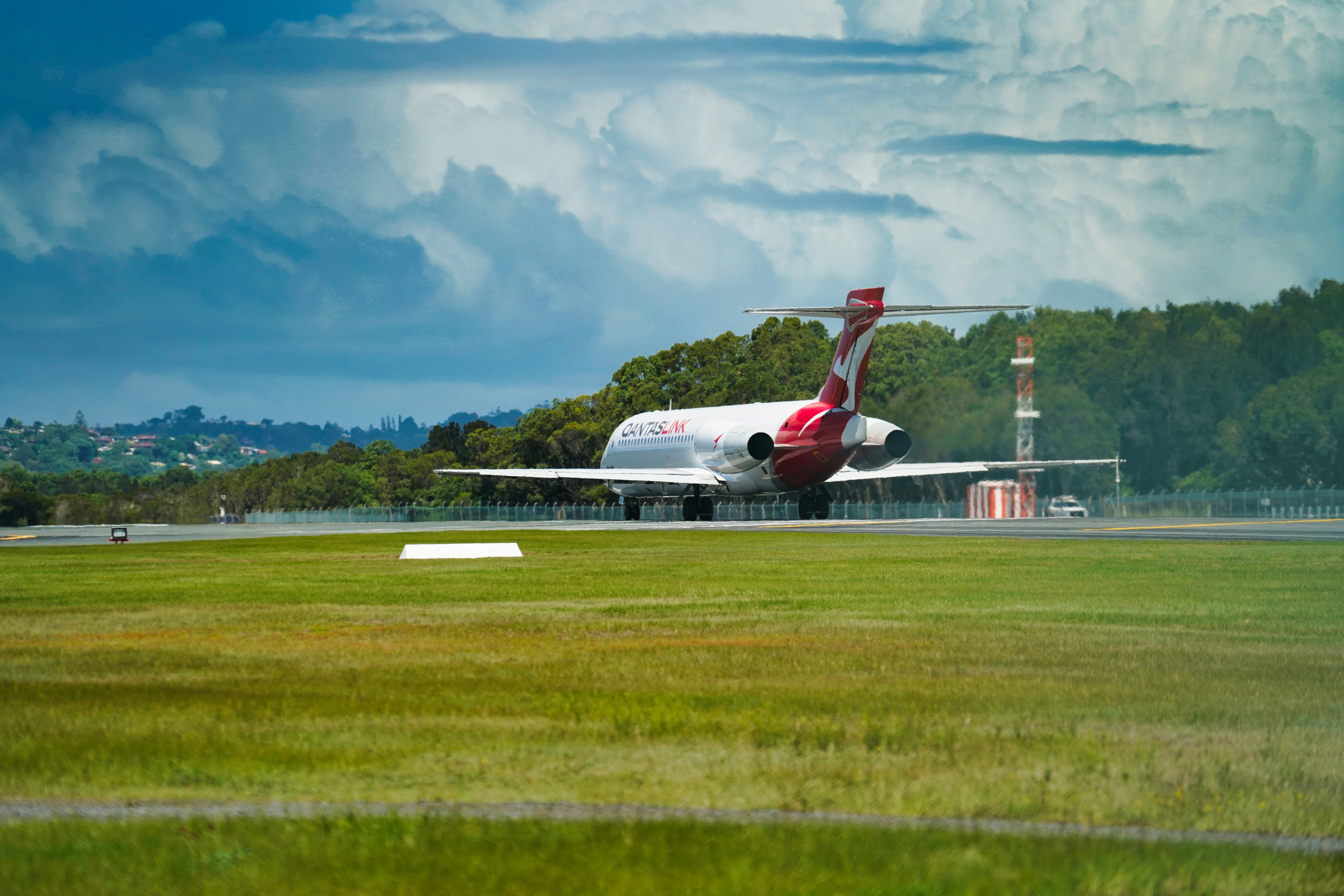 a large jetliner taking off from an airport runway, 