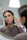 Photo of a woman admiring her elegant earrings in front of a mirror with natural light.