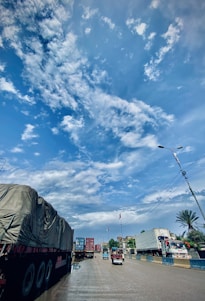 A reliable cargo truck on a city road with clear skies, representing local freight transport.