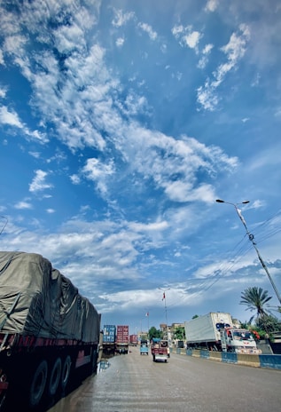 Close-up of a freight truck loaded and ready to depart under a clear blue sky.