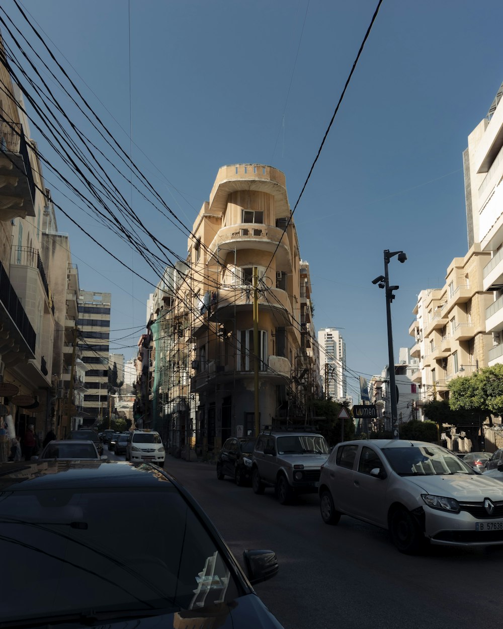 a city street filled with lots of traffic next to tall buildings