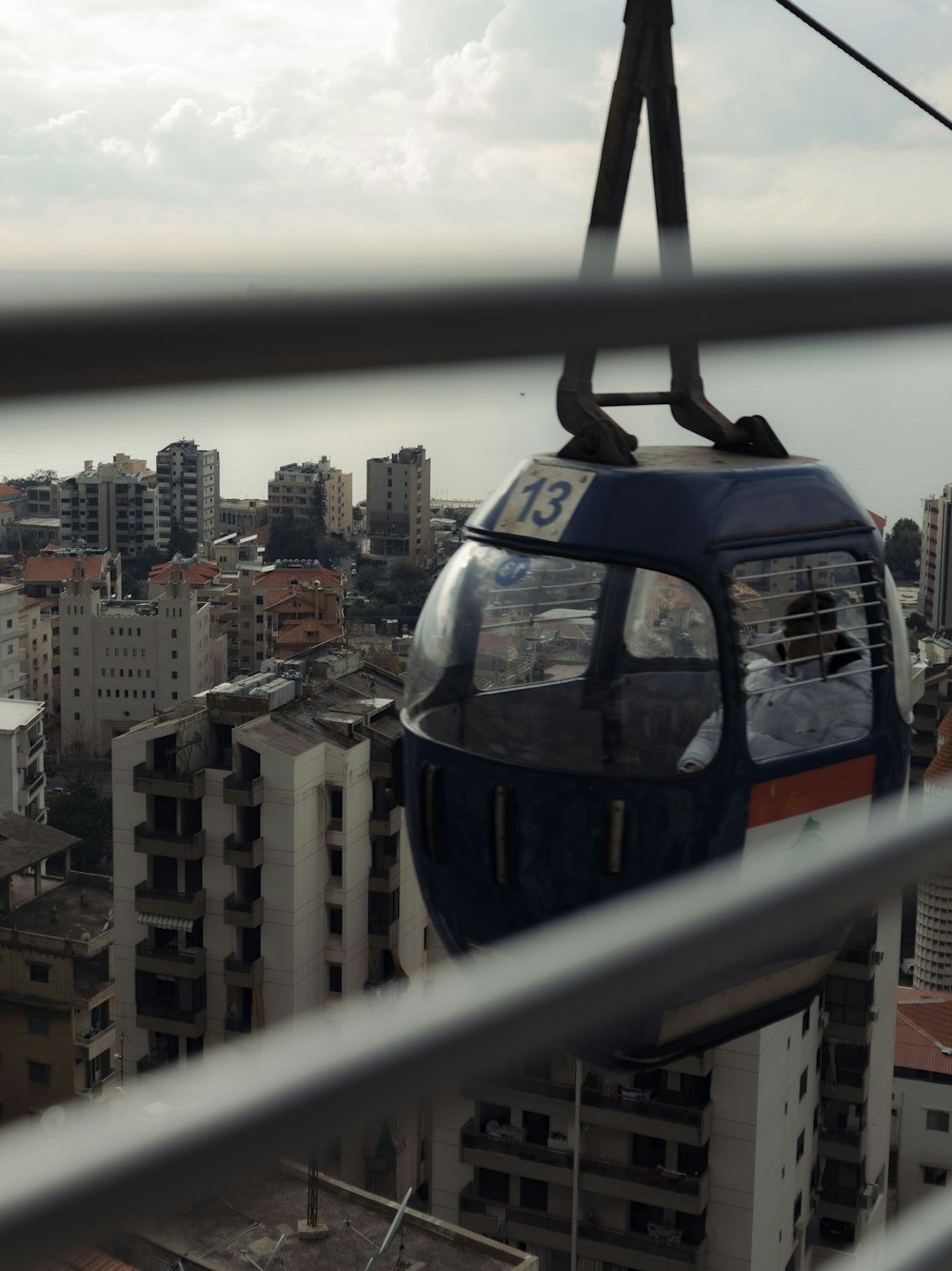 a cable car going over a city with tall buildings