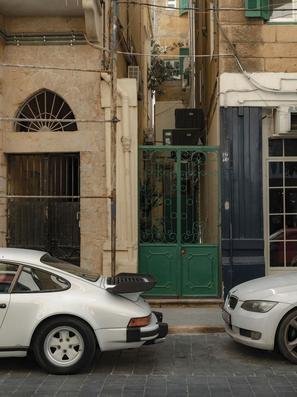 a couple of cars parked in front of a building