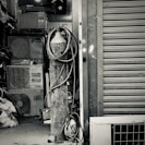 An assortment of HVAC components including compressors and filters on a workbench.