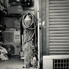 An assortment of HVAC components including compressors and filters on a workbench.