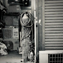 Technicians installing a large industrial air handling unit inside a modern facility.