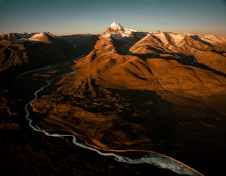 an aerial view of a mountain range with a river running through it