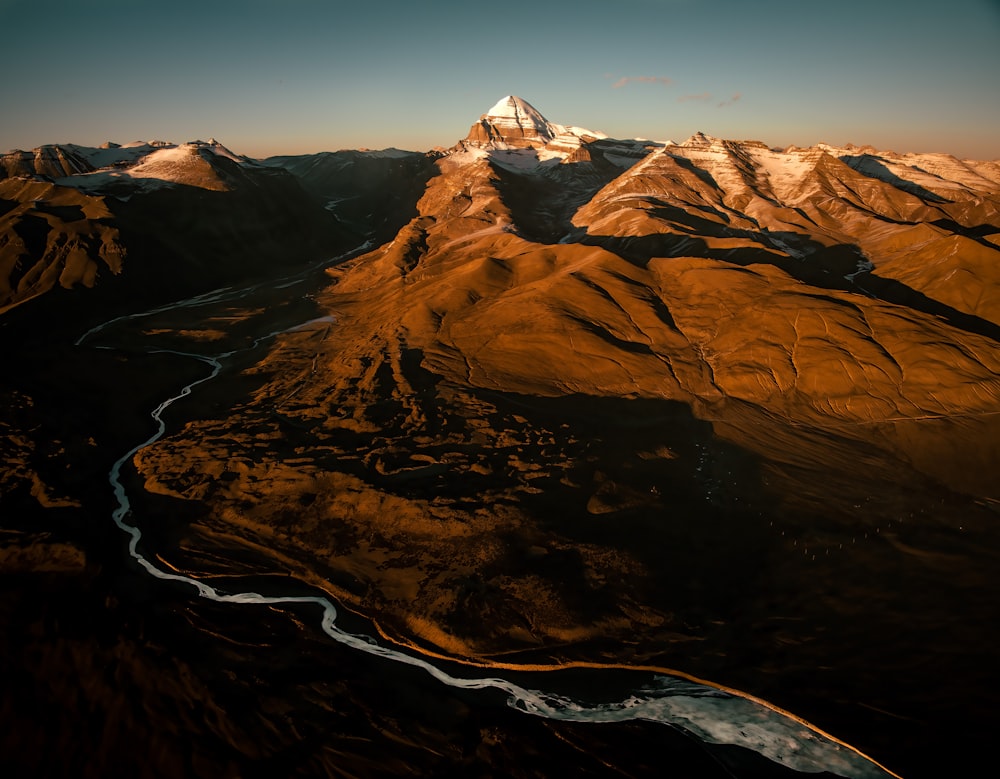 an aerial view of a mountain range with a river running through it