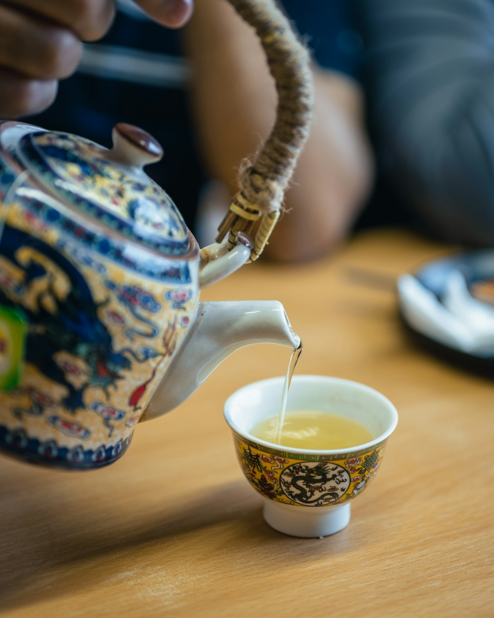 a teapot pouring tea into a cup