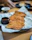 Close-up of crispy lumpias and golden fried chicken served with dipping sauces.
