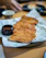 Close-up of crispy lumpias and golden fried chicken served with dipping sauces.