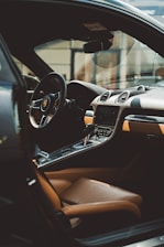the interior of a car with a steering wheel and dashboard