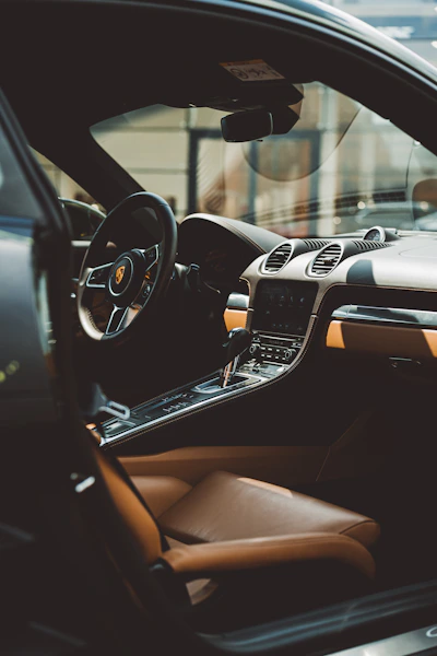 the interior of a car with a steering wheel and dashboard