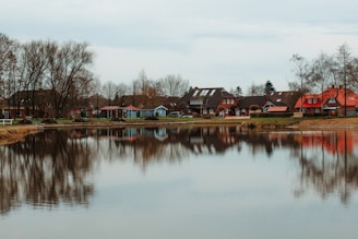 a body of water with houses in the background