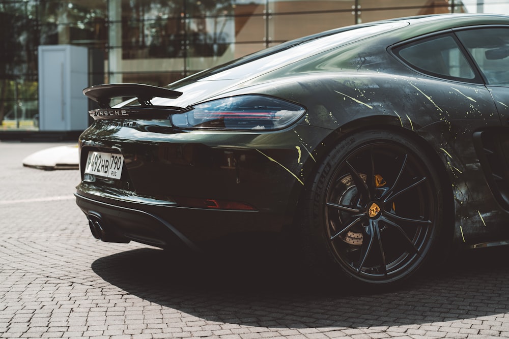 a black sports car parked in front of a building