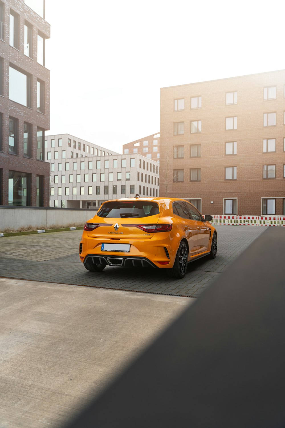 an orange sports car parked in a parking lot