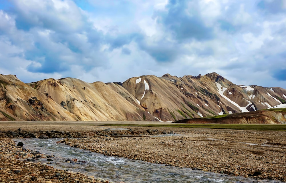 a mountain range with a stream running through it