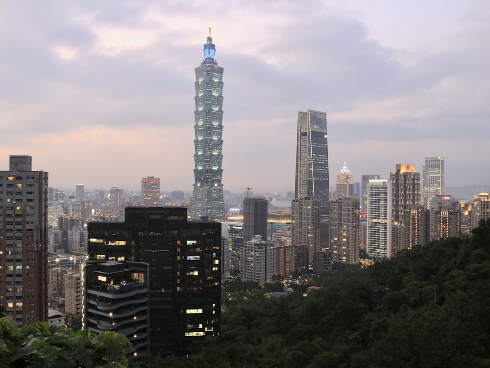 a view of a city at dusk from a hill